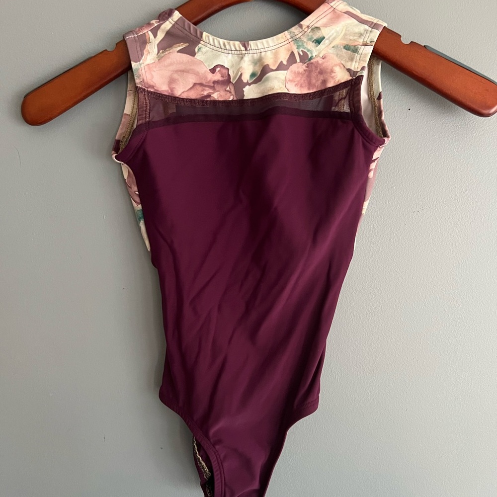 Beautiful Lucky Leo leotard. Purple with a pattern on the edges.